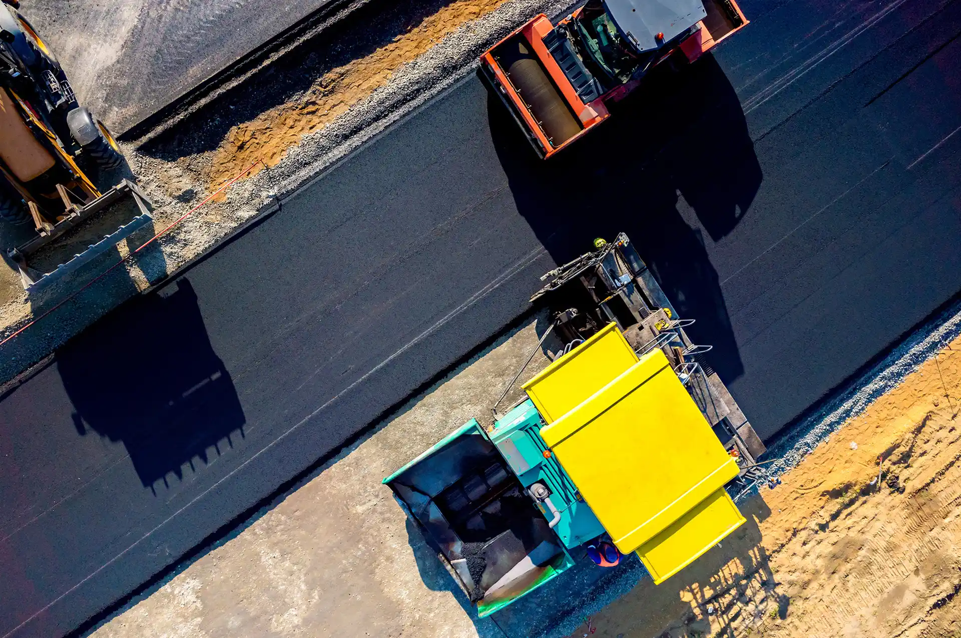 arial view of construction equipment paving a road